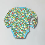 Colorful baby onesie with fruit pattern on a gray background