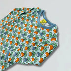 Baby top with colorful pattern on a light gray background