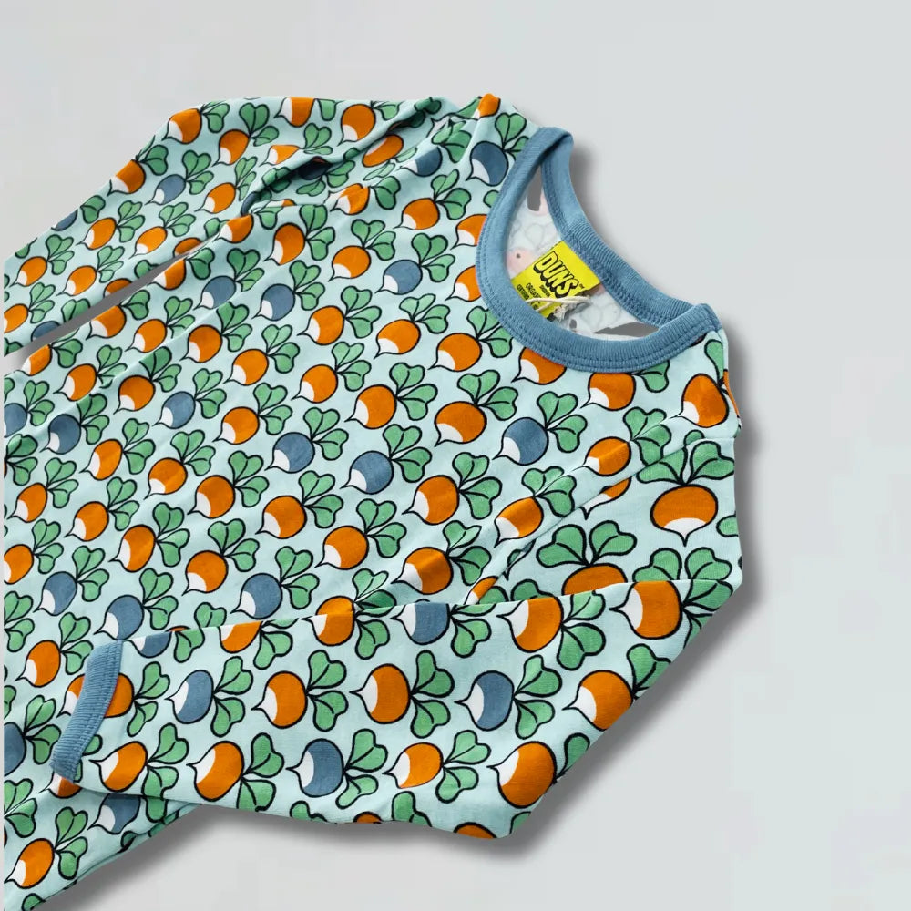 Baby top with colorful pattern on a light gray background