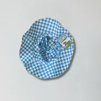 Blue and white checkered bucket hat with a visible brand label on a gray background