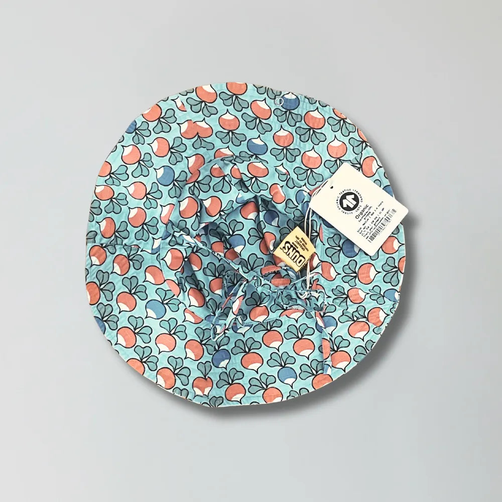 Floral-patterned baby hat with a tag on a gray background