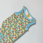 Baby romper with colorful mushroom pattern on a gray background