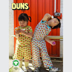 Two children wearing colorful outfits with a red door and 'DUNS' branding in the background.