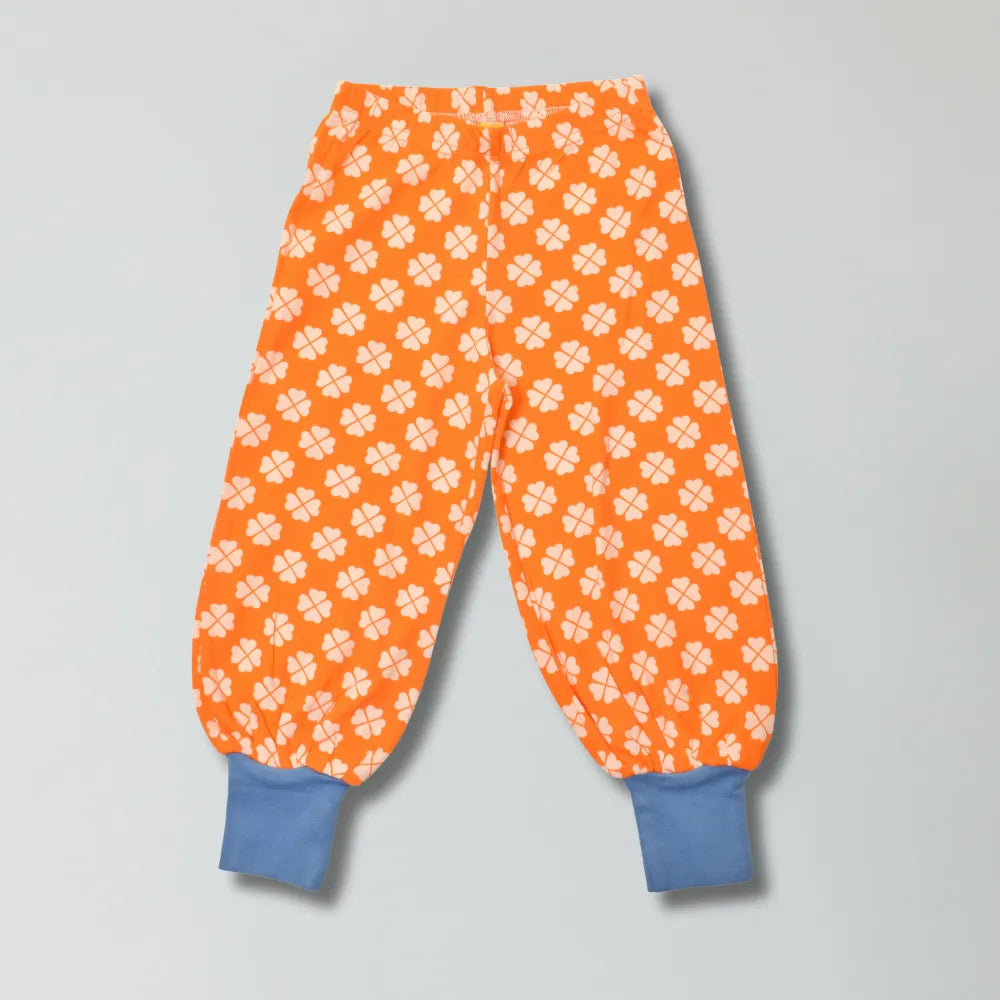 Vibrant orange clover print organic cotton baggy pants for babies and toddlers — Baby Goes Retro