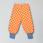 Vibrant orange clover print organic cotton baggy pants for babies and toddlers — Baby Goes Retro