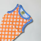 Orange baby romper with white floral pattern and blue trim on a light gray background