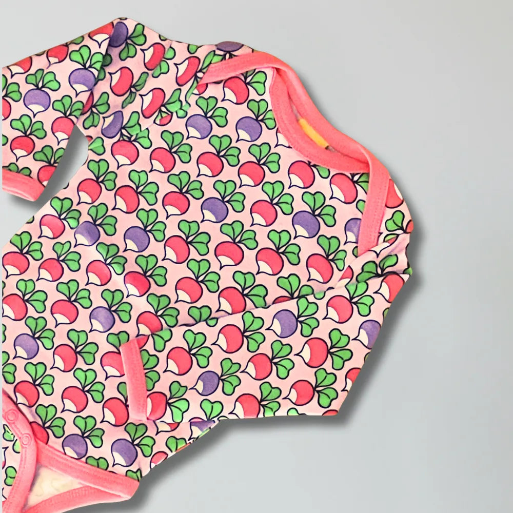 Baby onesie with colorful radish pattern on a gray background