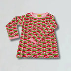 Pink dress with red and green pattern on a gray background