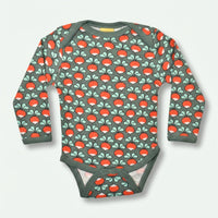 Children's long-sleeve bodysuit with red mushroom pattern on a light gray background