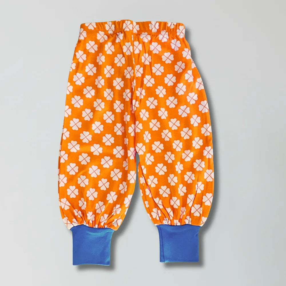 Orange pants with white pattern on a gray background