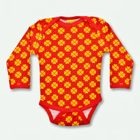 Red baby onesie with yellow pattern on a white background