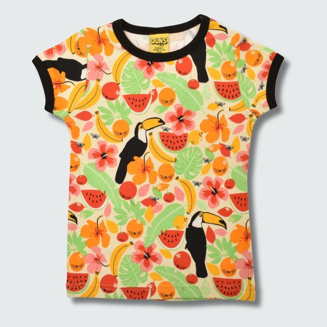 Colorful t-shirt with tropical fruit and bird pattern on a light gray background