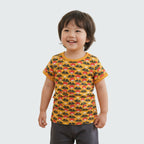 Child wearing a yellow t-shirt with a pattern on a white background