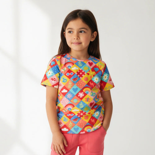 Child wearing a colorful patterned shirt against a white background