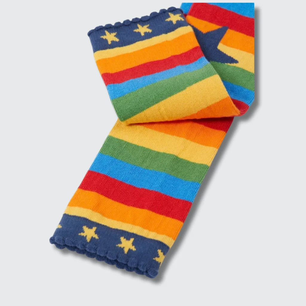 Close-up of the navy scalloped cuff with yellow stars on the rainbow striped leggings
