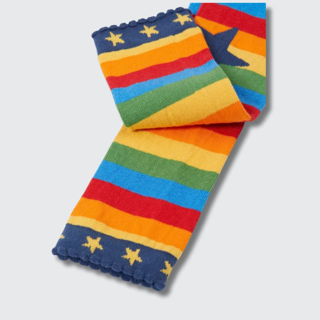 Close-up of the navy scalloped cuff with yellow stars on the rainbow striped leggings