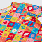 Colorful children's apron with various patterns on a white background