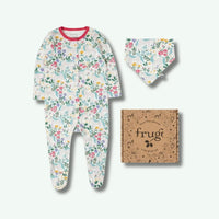Baby onesie with floral pattern, matching hat, and 'frugi' branded box on a white background