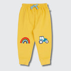 Yellow children's sweatpants with rainbow and car design on a light gray background