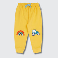 Yellow children's sweatpants with rainbow and car design on a light gray background