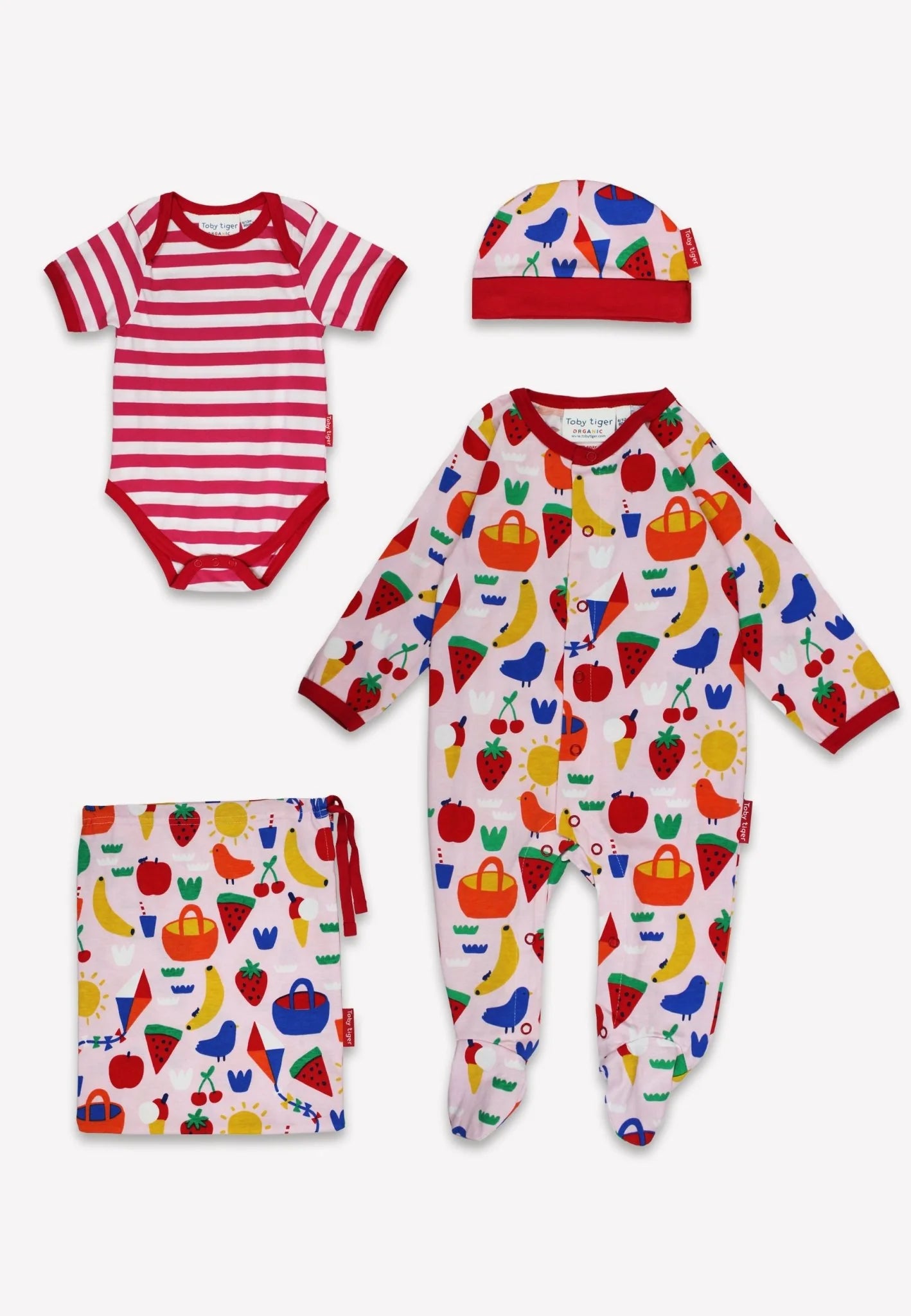 Baby clothing set with striped onesie, patterned romper, and hat on a white background