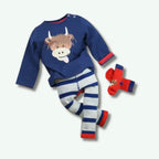 Children's outfit with blue shirt, striped pants, and socks on a white background