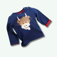 Navy blue sweater with a cartoon cow design on a white background