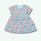 Children's dress with dog and flower pattern on a light blue background