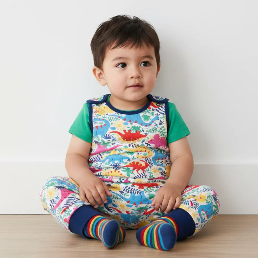 Infant boy wearing a dino romper
