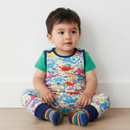 Infant boy wearing a dino romper