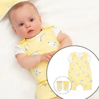 Baby wearing a yellow romper with butterfly pattern on a white background