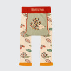 Toddler leggings from Blade & Rose featuring a woodland hedgehog and autumn leaf pattern on a cream base, with a sage green front pocket and a red waistband.