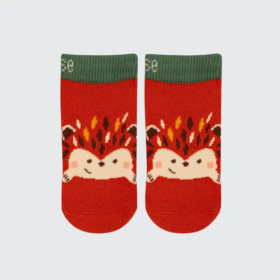 A pair of red knit ankle socks with a green ribbed cuff, featuring a cute cartoon hedgehog design on the front.