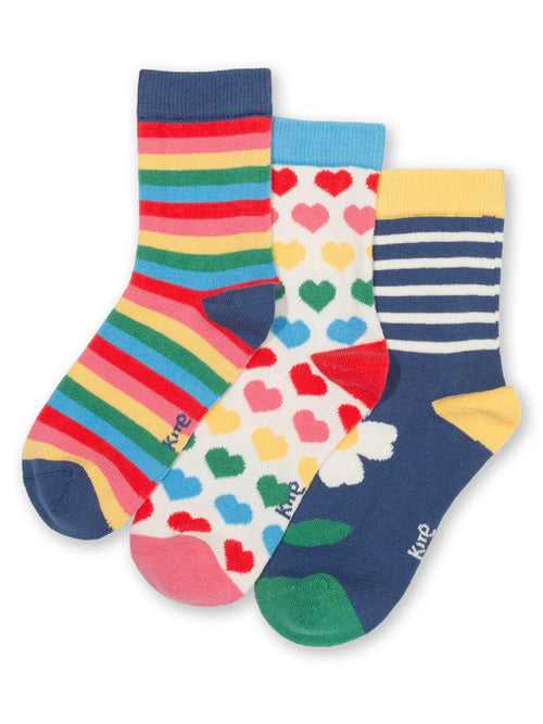 Three pairs of colorful socks with different patterns on a white background