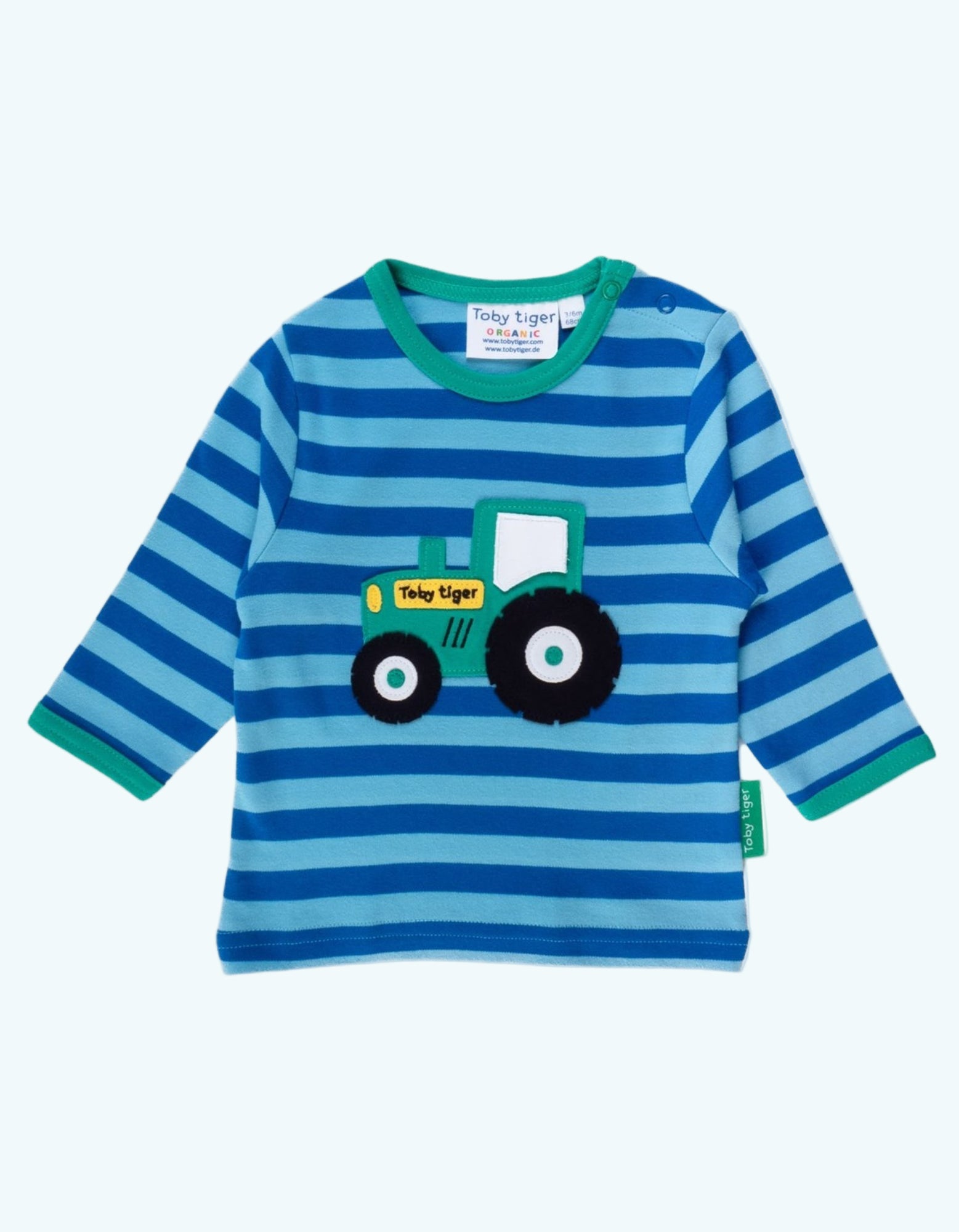 Blue and green striped shirt with a tractor design on a white background