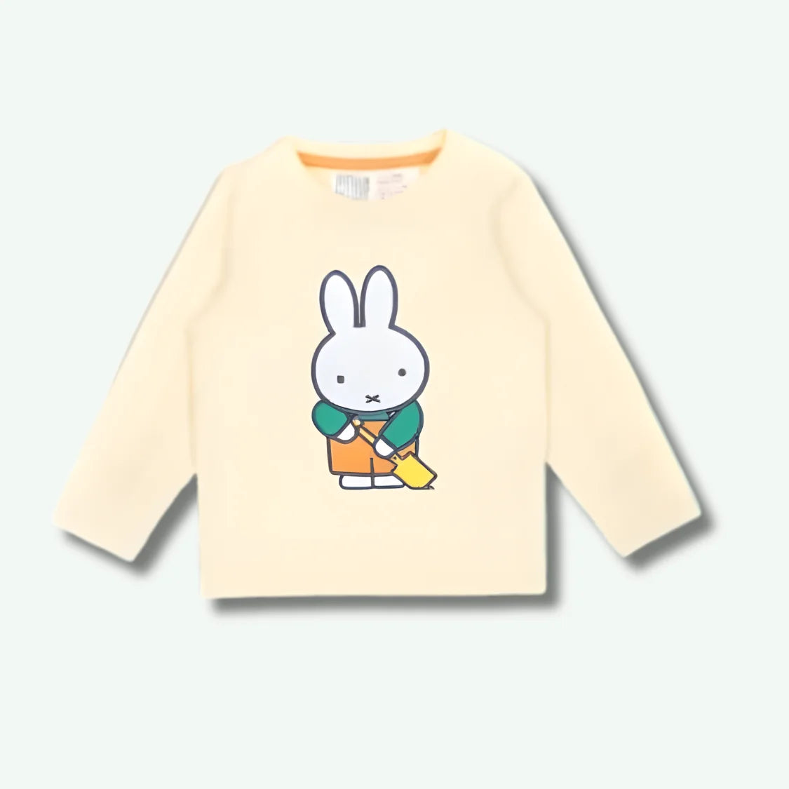 Beige long-sleeve shirt with a cartoon character on a white background
