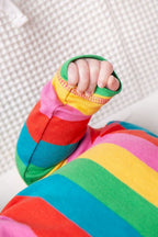 Colorful striped socks worn by a child on a white background