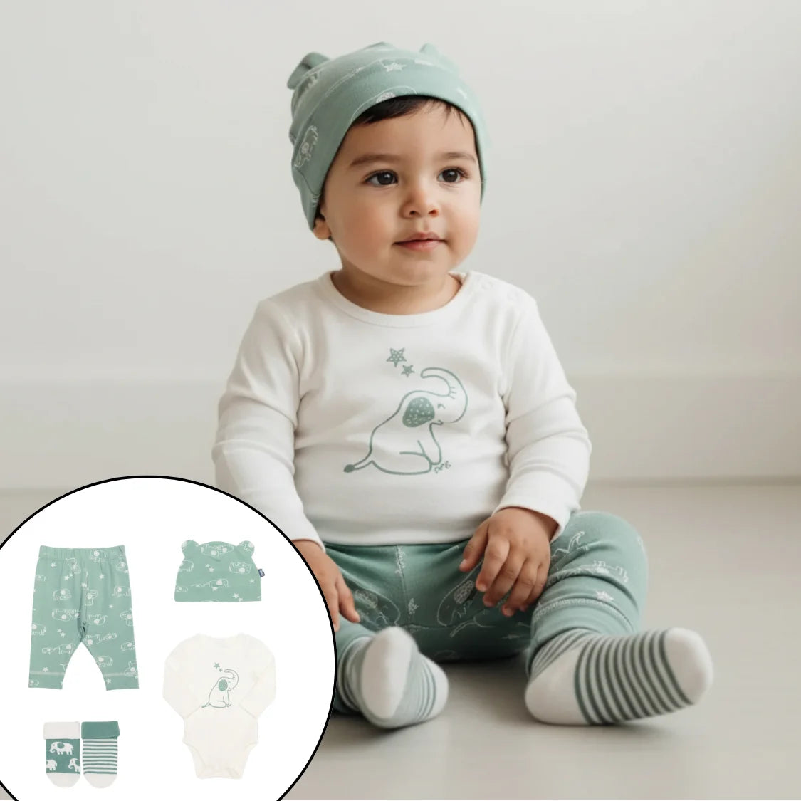 Baby wearing a white shirt with a dinosaur design, green pants, and a matching hat on a light background.