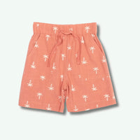 Peach-colored shorts with white palm tree pattern on a light gray background