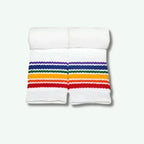 White tube top with rainbow striped shorts on a white background