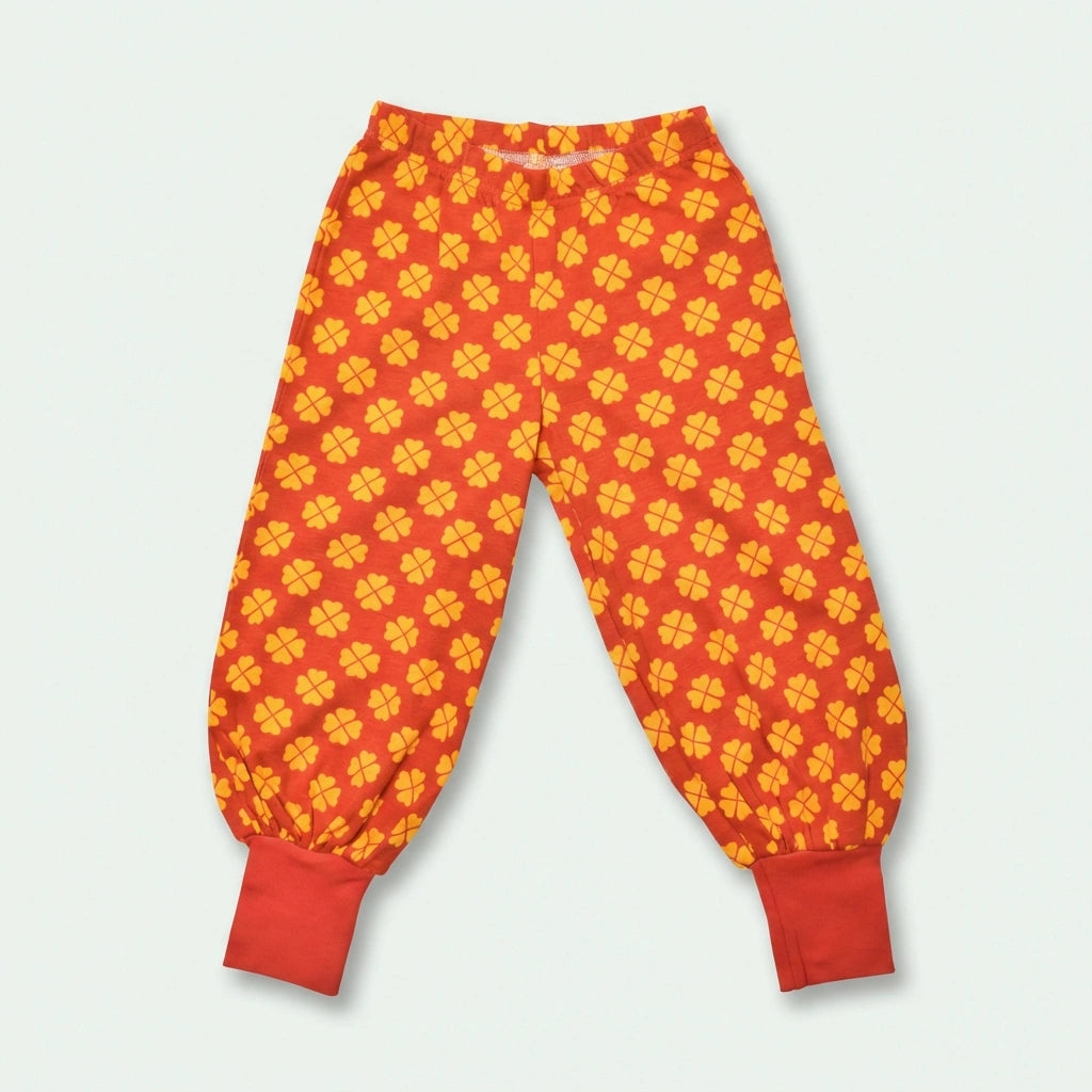 Red pants with yellow pattern on a light gray background