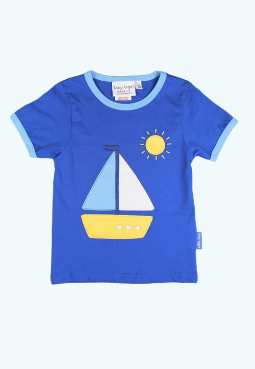 Blue t-shirt with sailboat and sun design on a white background