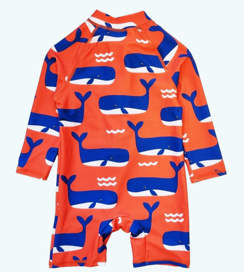 Orange swimsuit with blue whale pattern on a white background