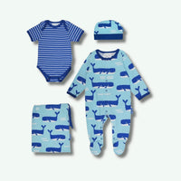 Set of blue baby clothing with whale patterns on a white background